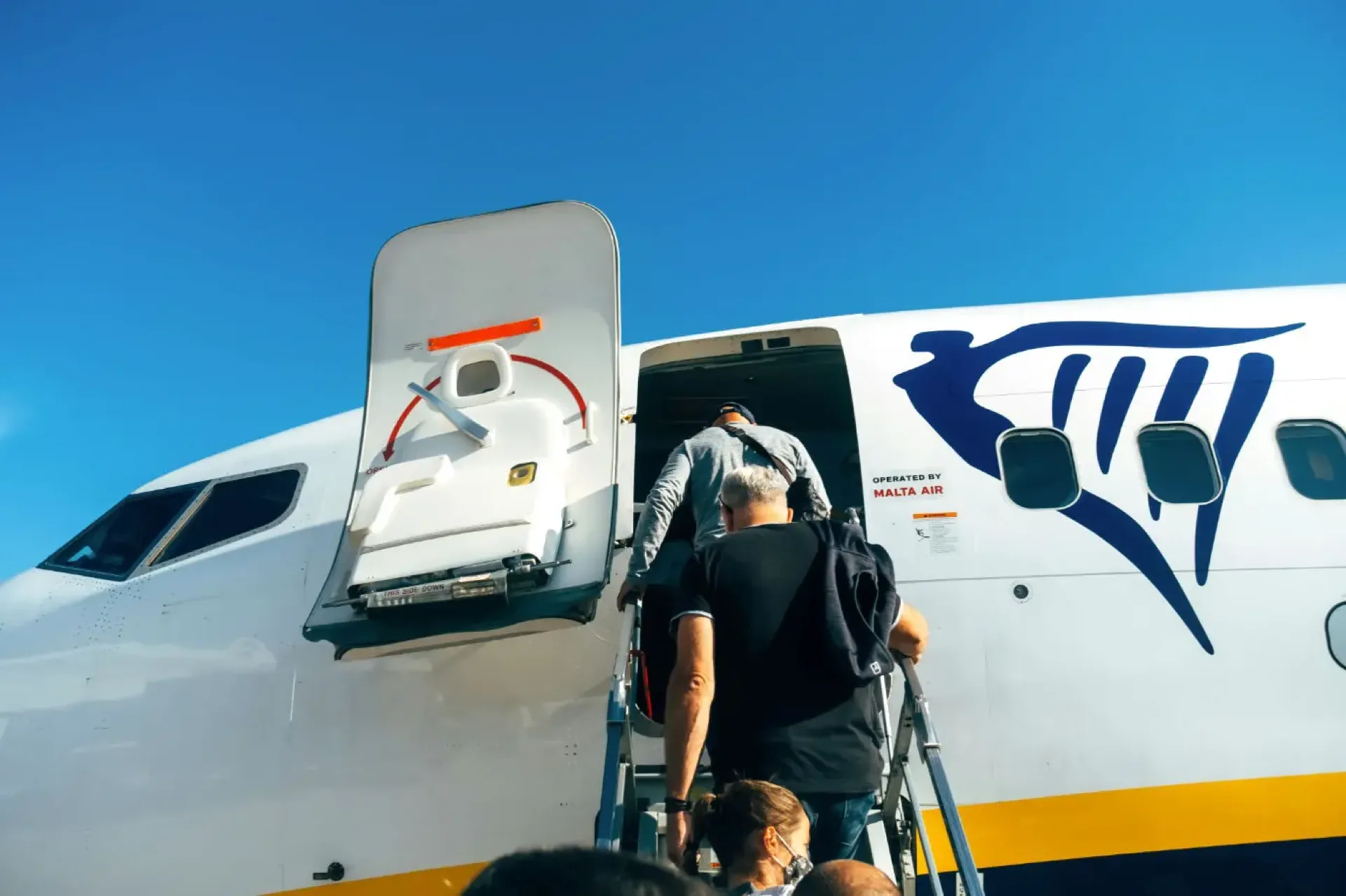 passengers boarding plane from front